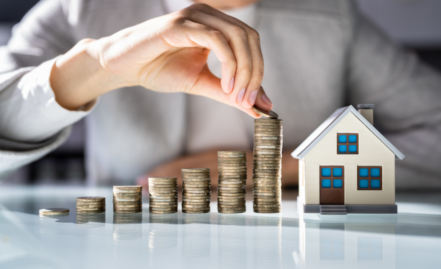 Stacks of coins growing next to a small model house